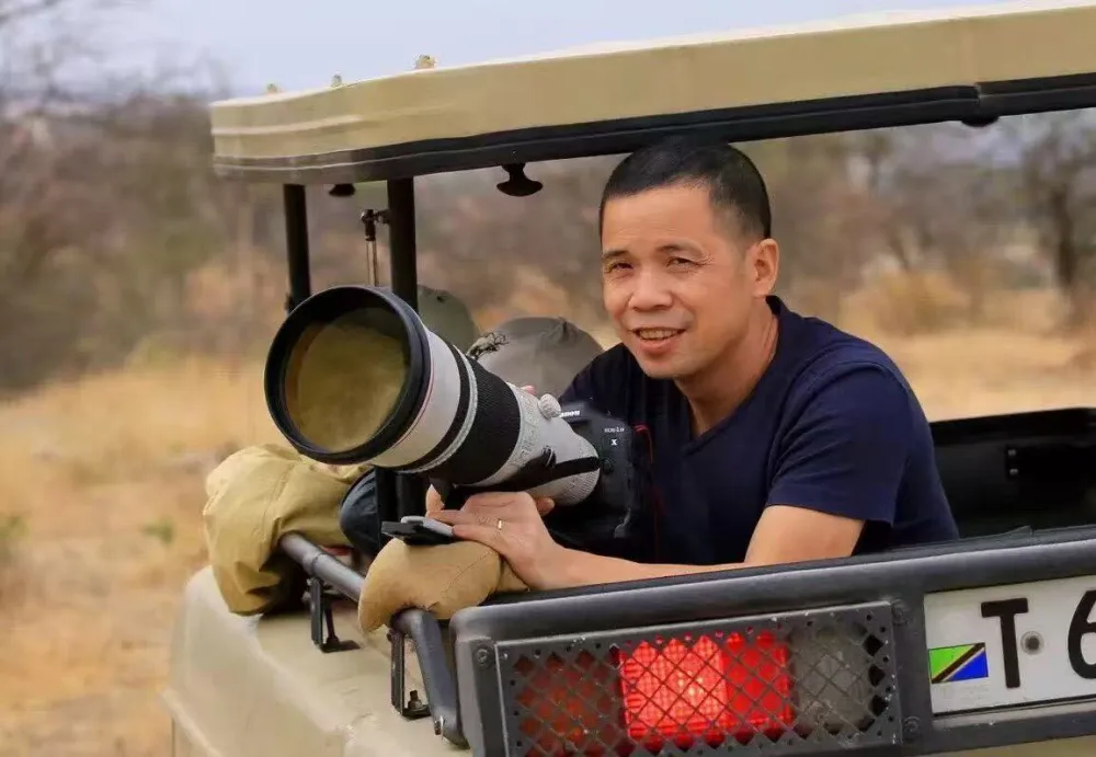 Danny Du with a camera on safari