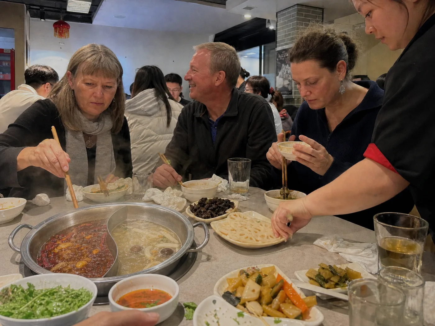 Joy Traveller guests sharing a Sichuan hotpot meal